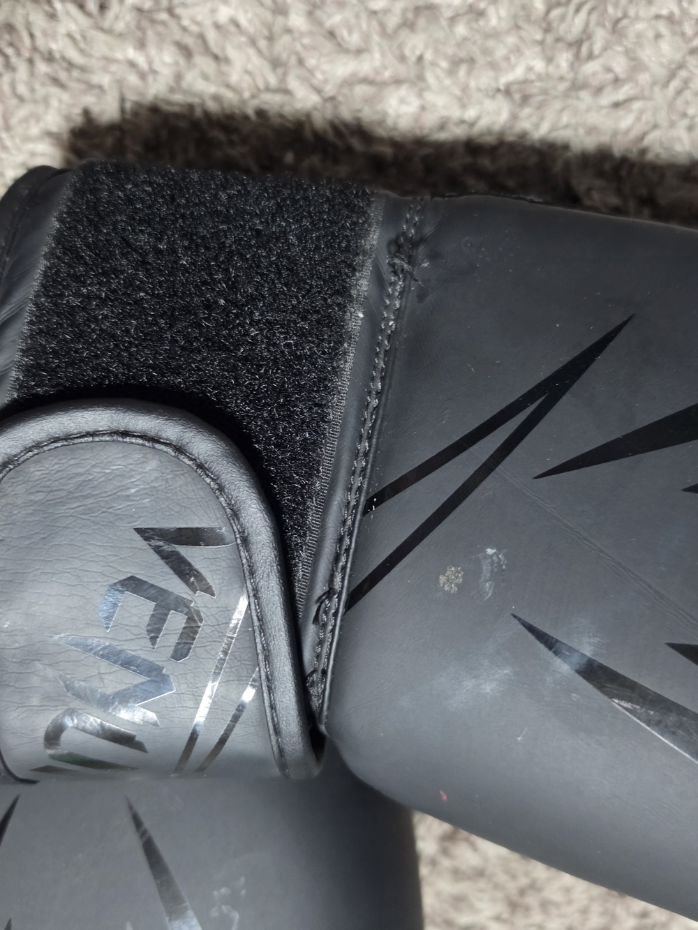 Sleek Matte Black Boxing Gloves with Subtle Logo